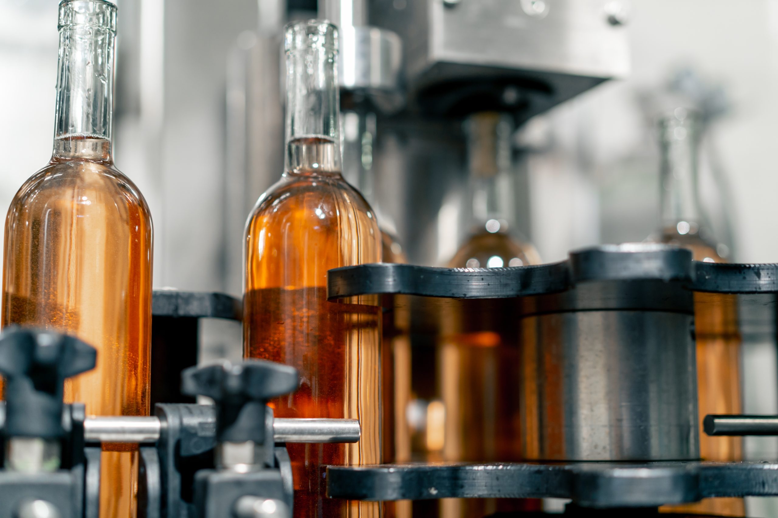 Transparent,Glass,Bottles,Filled,With,Wine,Are,Arranged,In,A